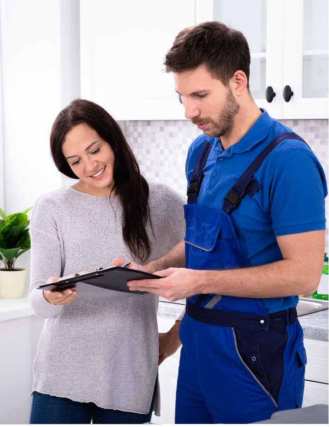 male dishwasher sevice man showing invoice to woman